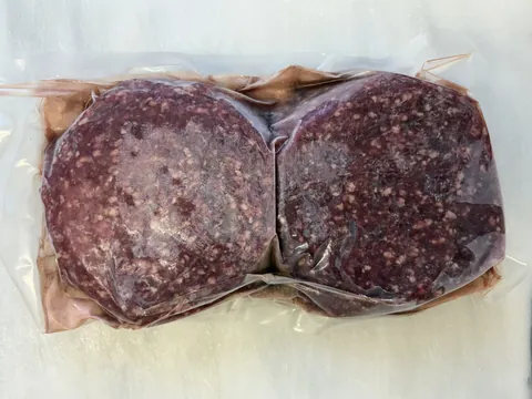 Hamburger Patties (6 oz), vacuum-sealed pack.