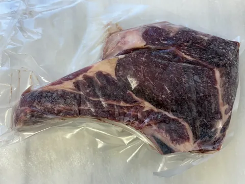 Rib Steak, Bone-In, vacuum-sealed pack.